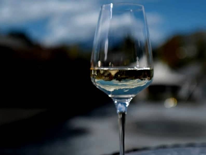 Glass of white wine on a table outdoors