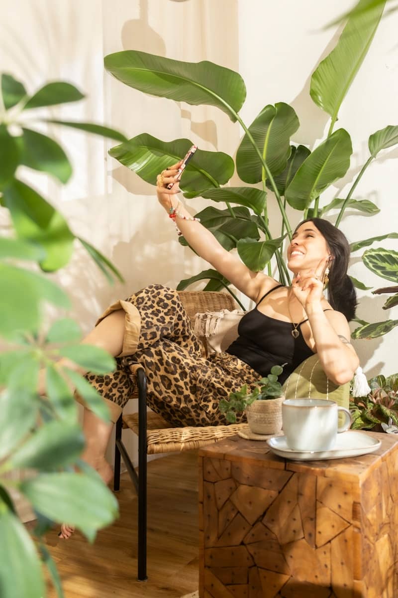 Woman taking a selfie in a room full of plants