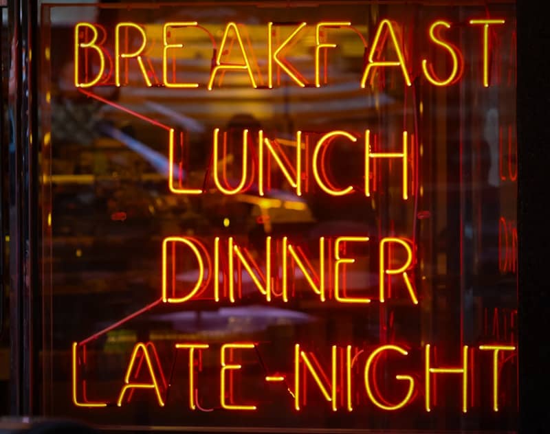 Neon sign advertises breakfast, lunch, dinner, and late-night.