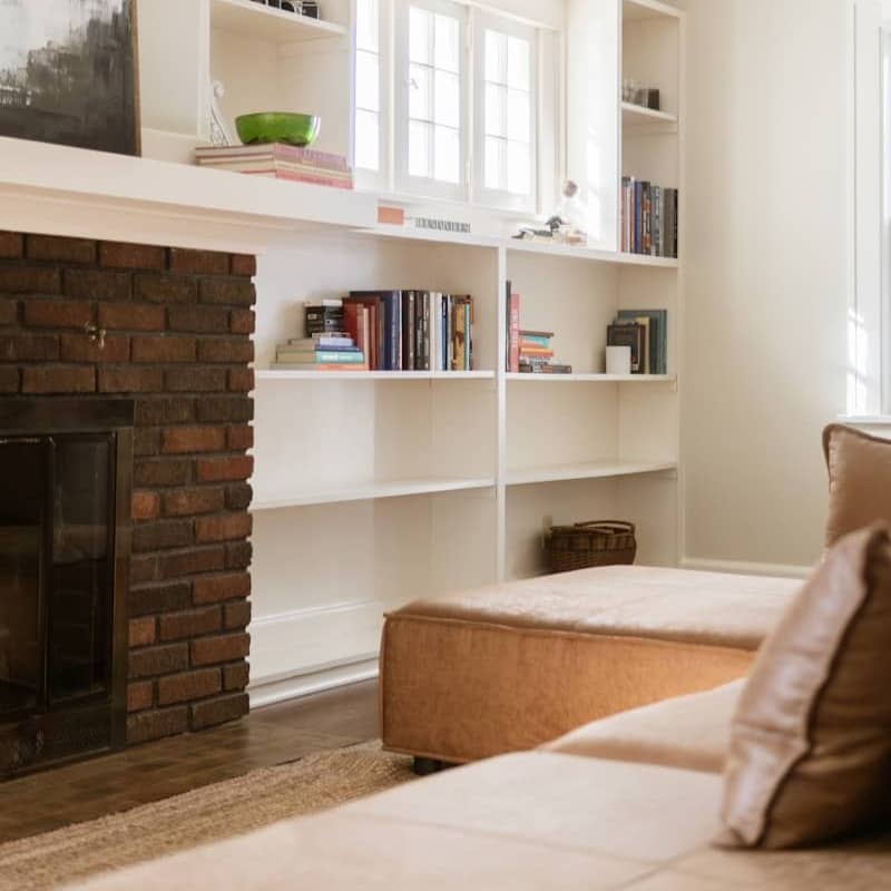 Living room with fireplace and built-in bookshelves