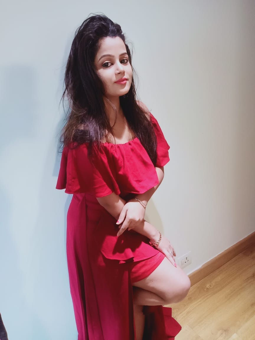 red dressed pune escort girl standing to wall