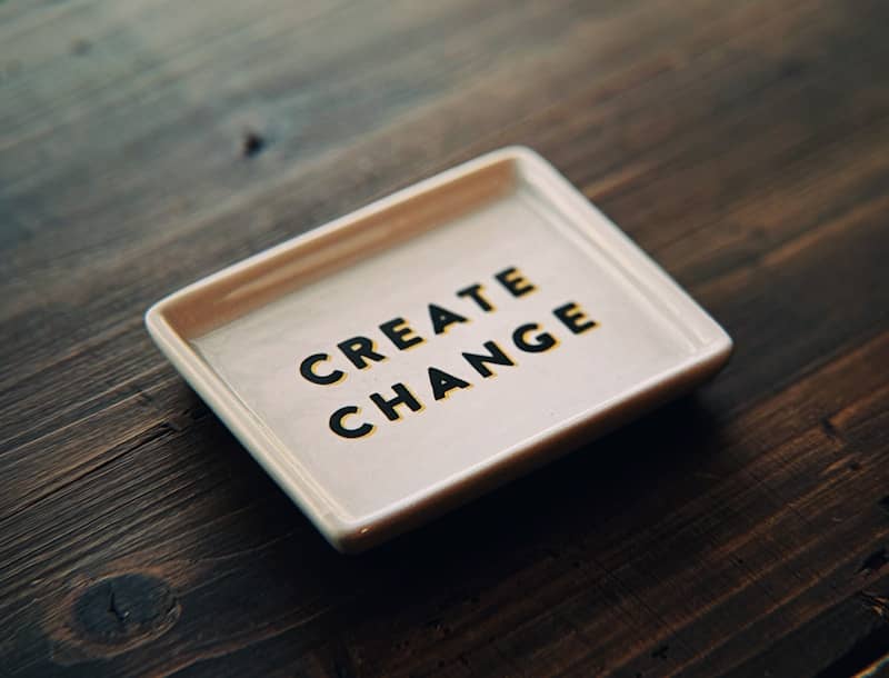 A white tray with the words create change written on it