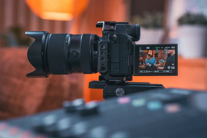 A professional video camera on a tripod filming
