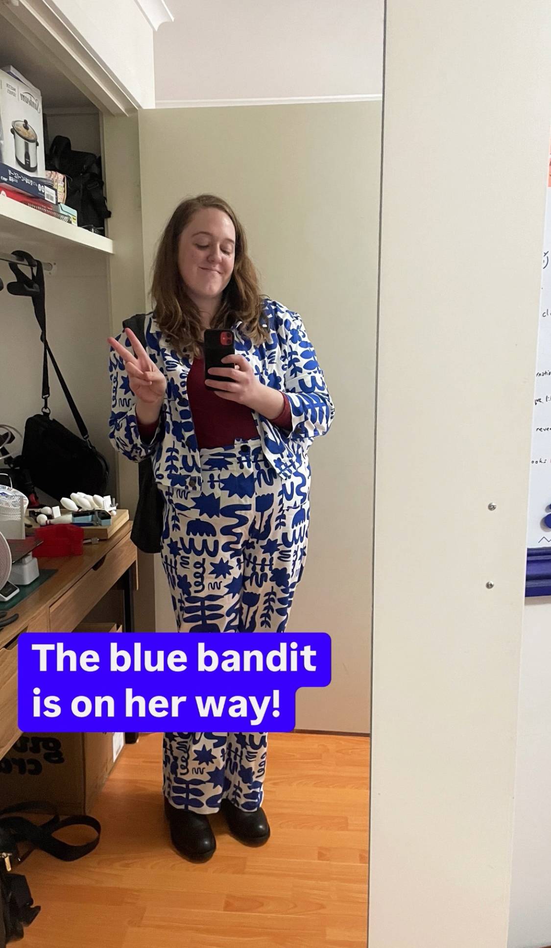 Shannon dressed in an outlandish white suit with bright blue squiggles over it.