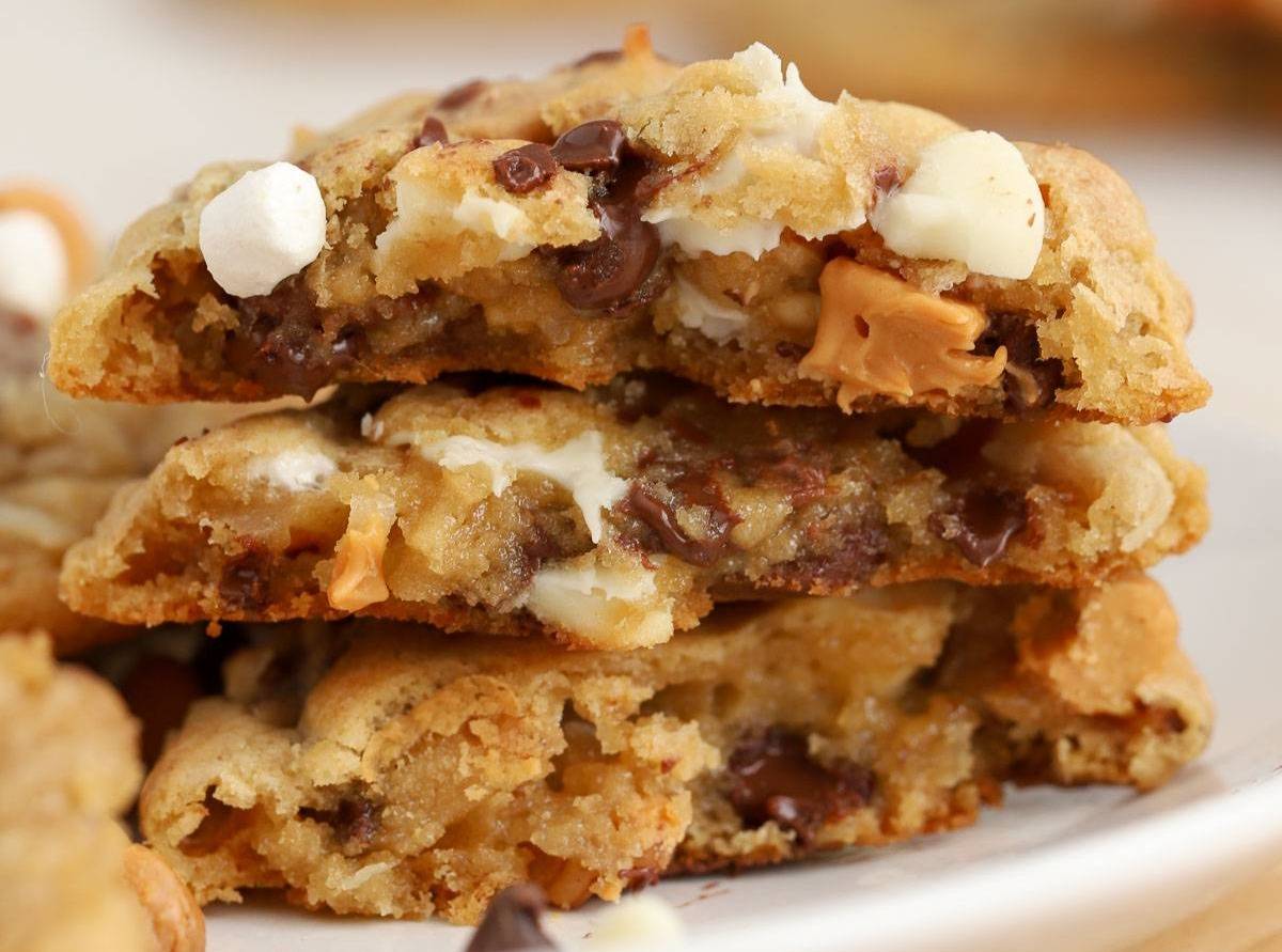 Three cookie halves stacked on top of each other on a white plate.