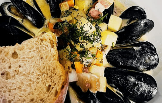 A bowl of mussels with bread at Marée