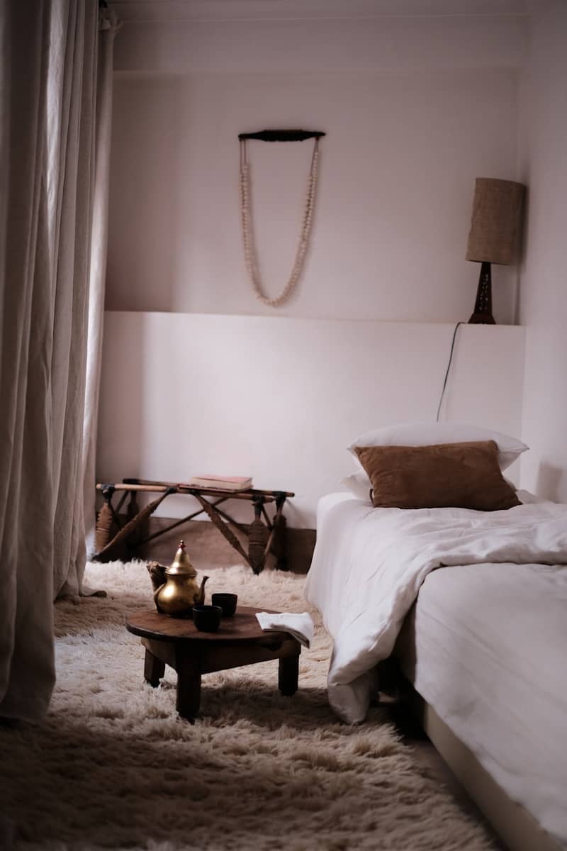 Cozy, minimalist bedroom with cultural decor.