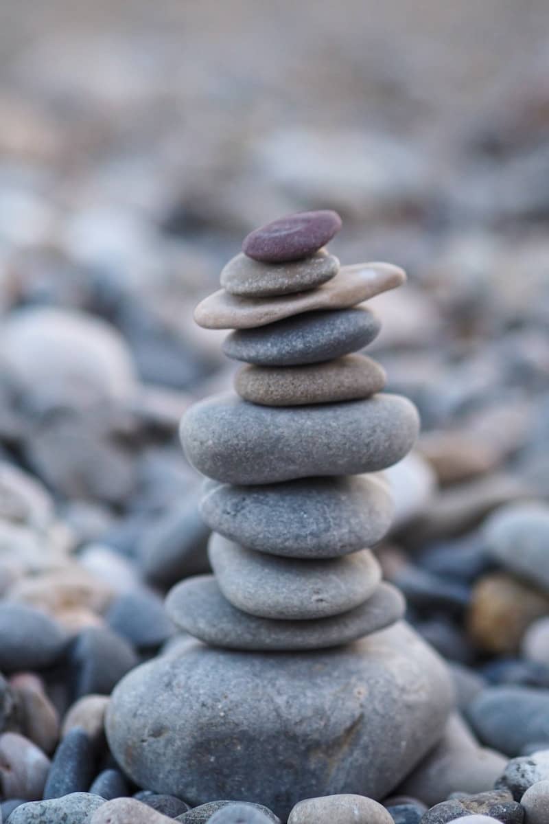 A stack of balanced zen stones on a rocky beach.