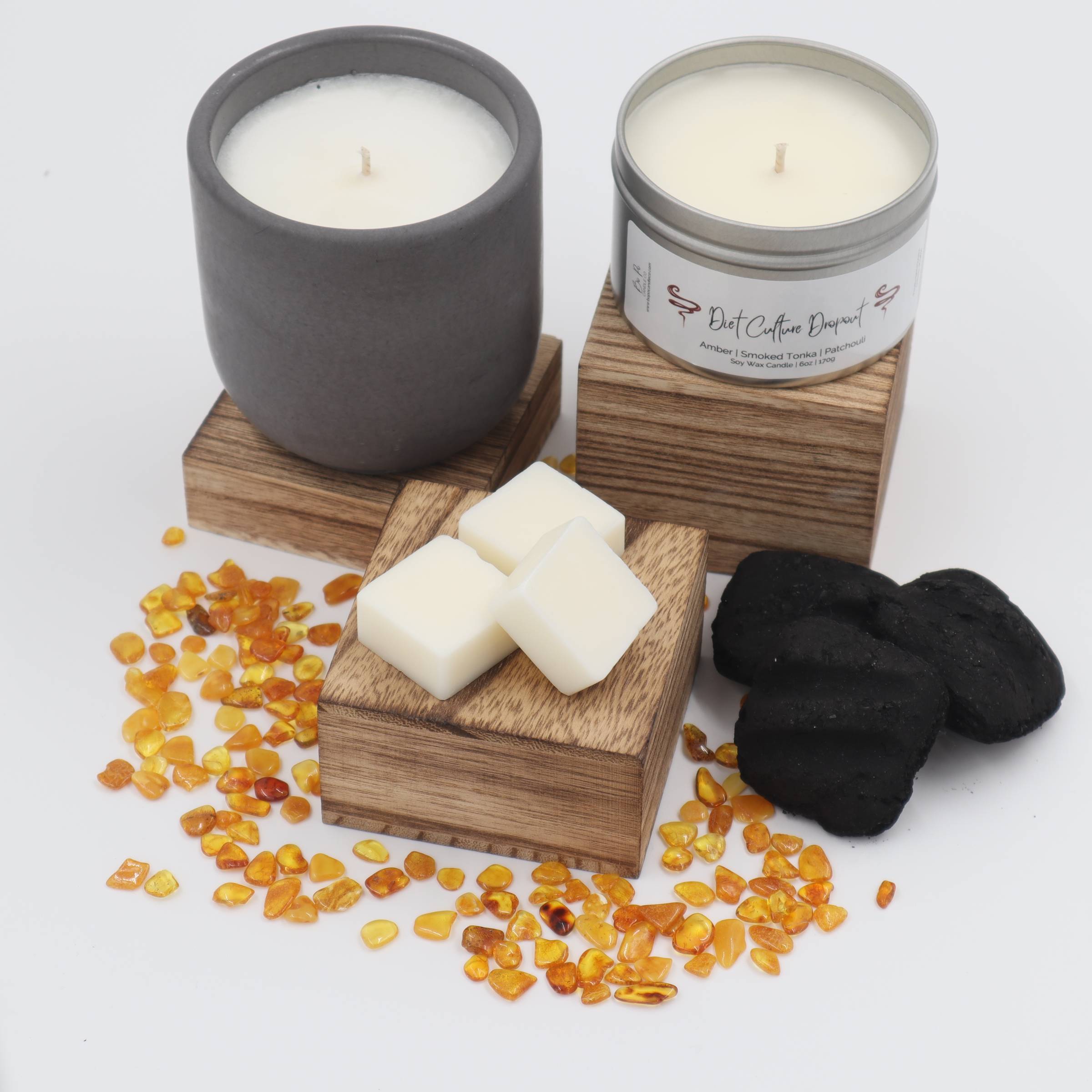 white candle on white ruled paper beside white ceramic mug