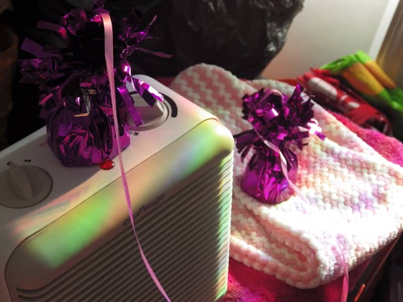 Two purple gift bags on a white appliance.