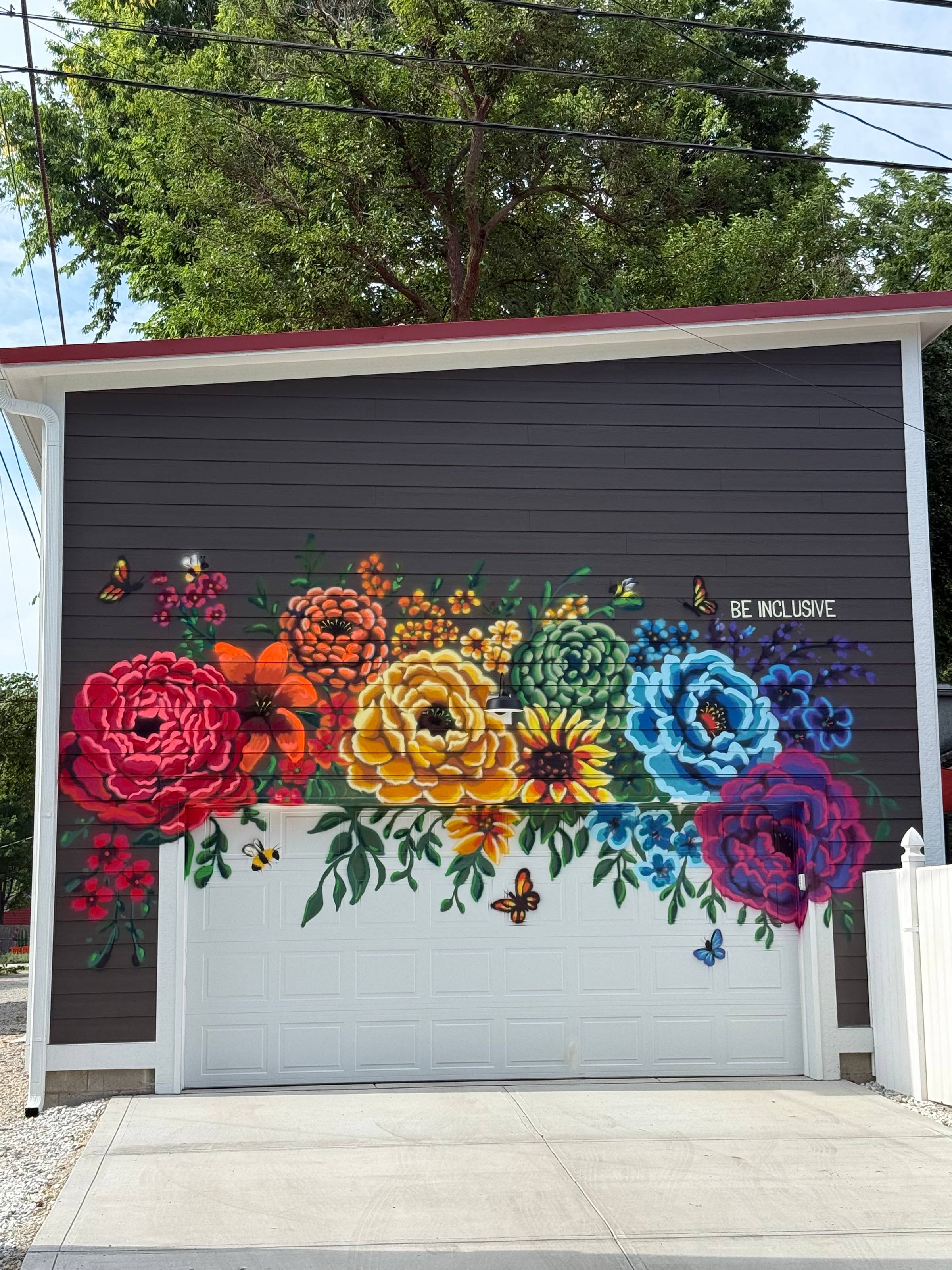 A garage with a colorful flower mural painted on it.