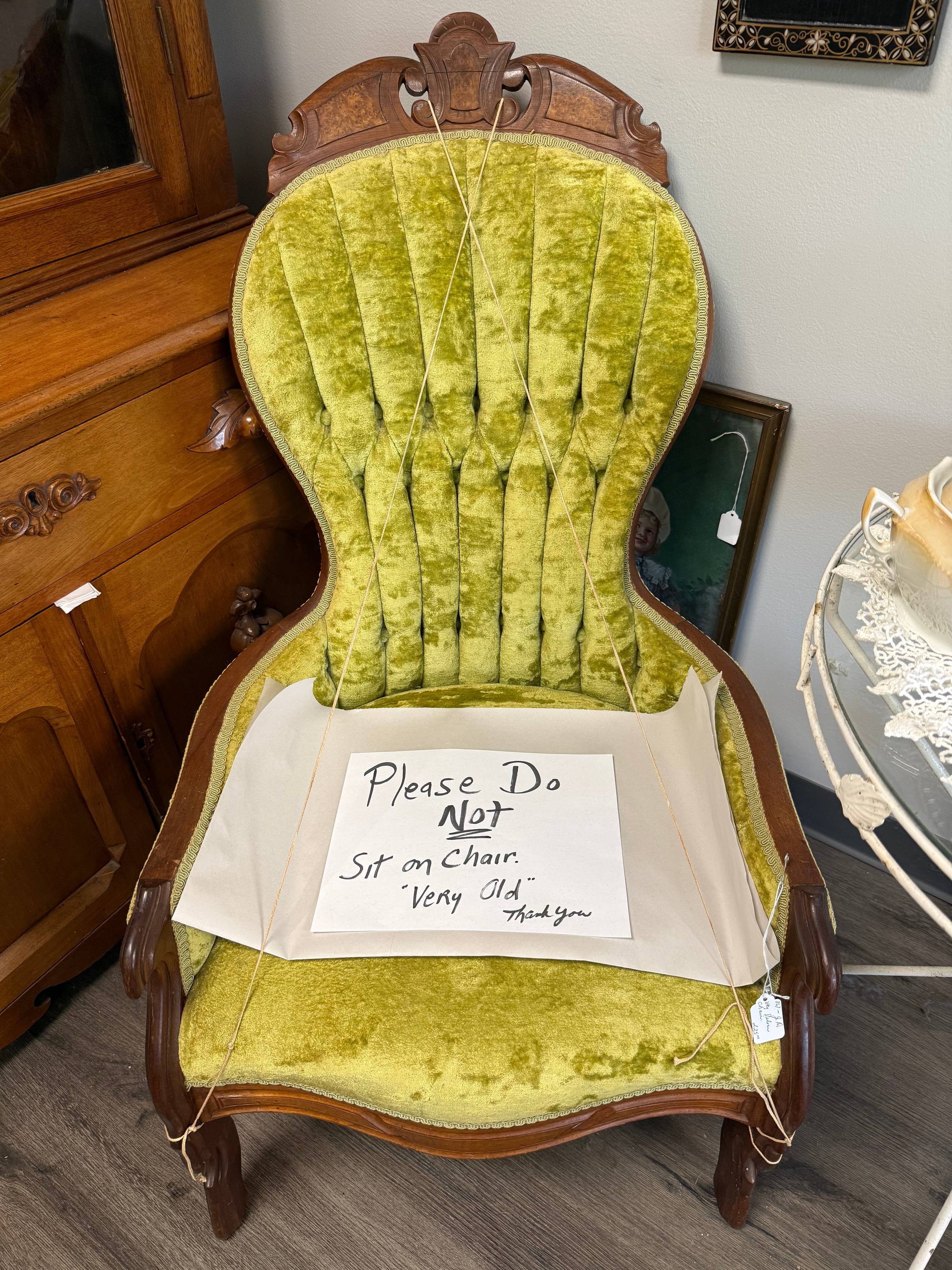 Sign reads "Please Do Not Sit on Chair Very Old Thank You"