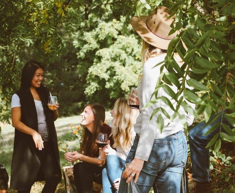 group of women in forest drinking