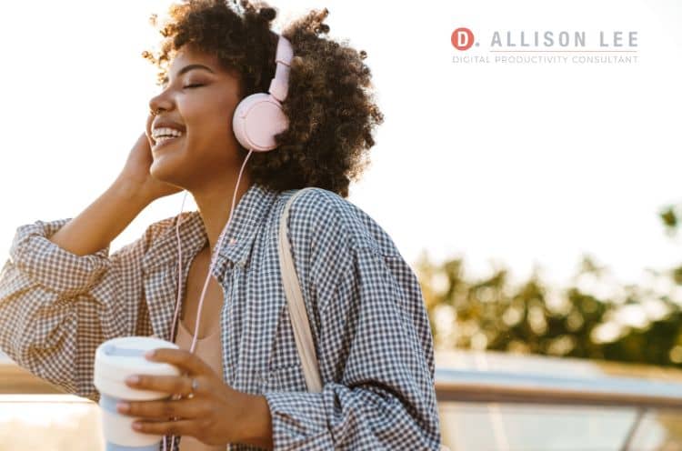 smiling woman outside with headphones on