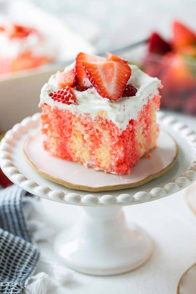 strawberry jello poke cake on a plate