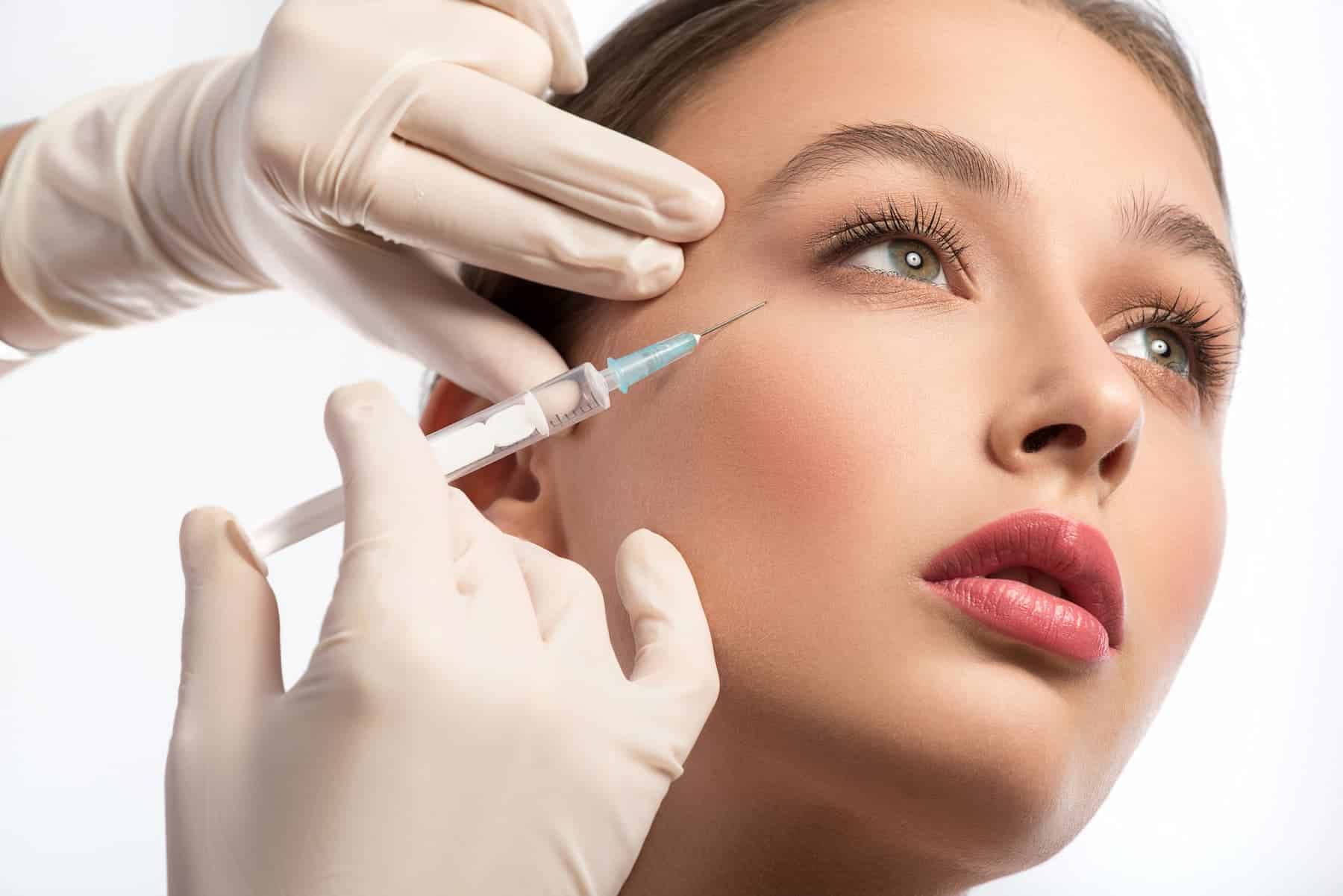 Close up of a young woman receiving Botox injection.