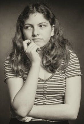 woman in stripe shirt covering her mouth with her hand