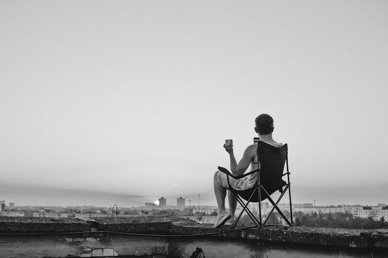 A man sitting in a chair on top of a roof