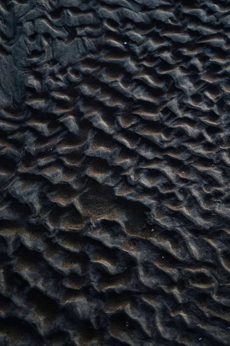 Rippled sand creates a textured pattern.