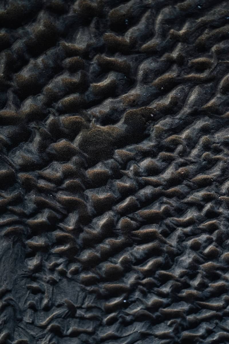 Rippled sand creates a textured pattern.