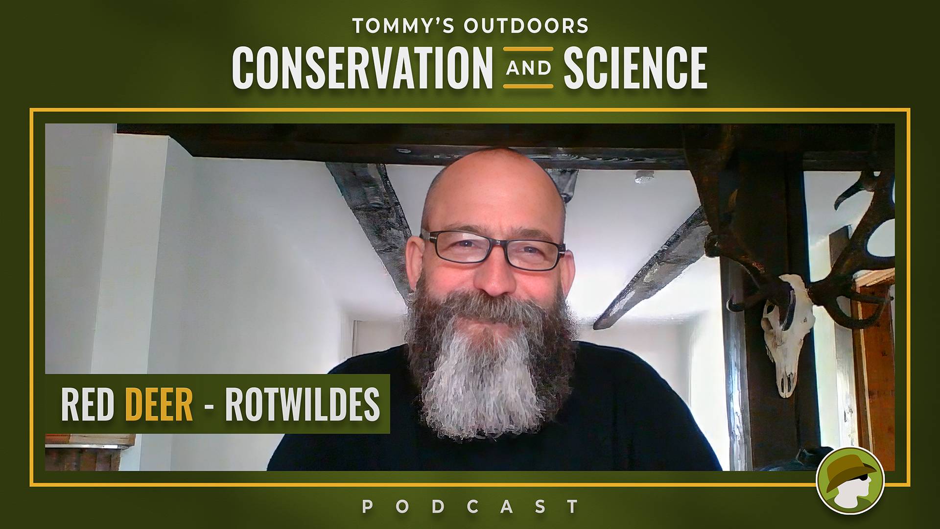Cover art for the 'Red Deer – RotWildes' episode of the Tommy's Outdoors Conservation and Science Podcast, featuring a smiling bald man with a full grey-streaked beard and dark-rimmed glasses, photographed during a video call. He is wearing a dark top and