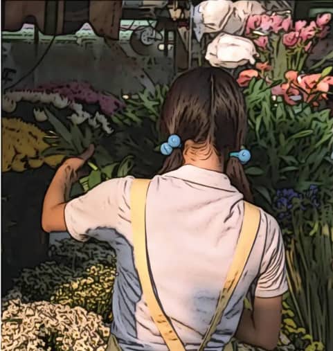 Girl with blue ribbons at a flower shop
