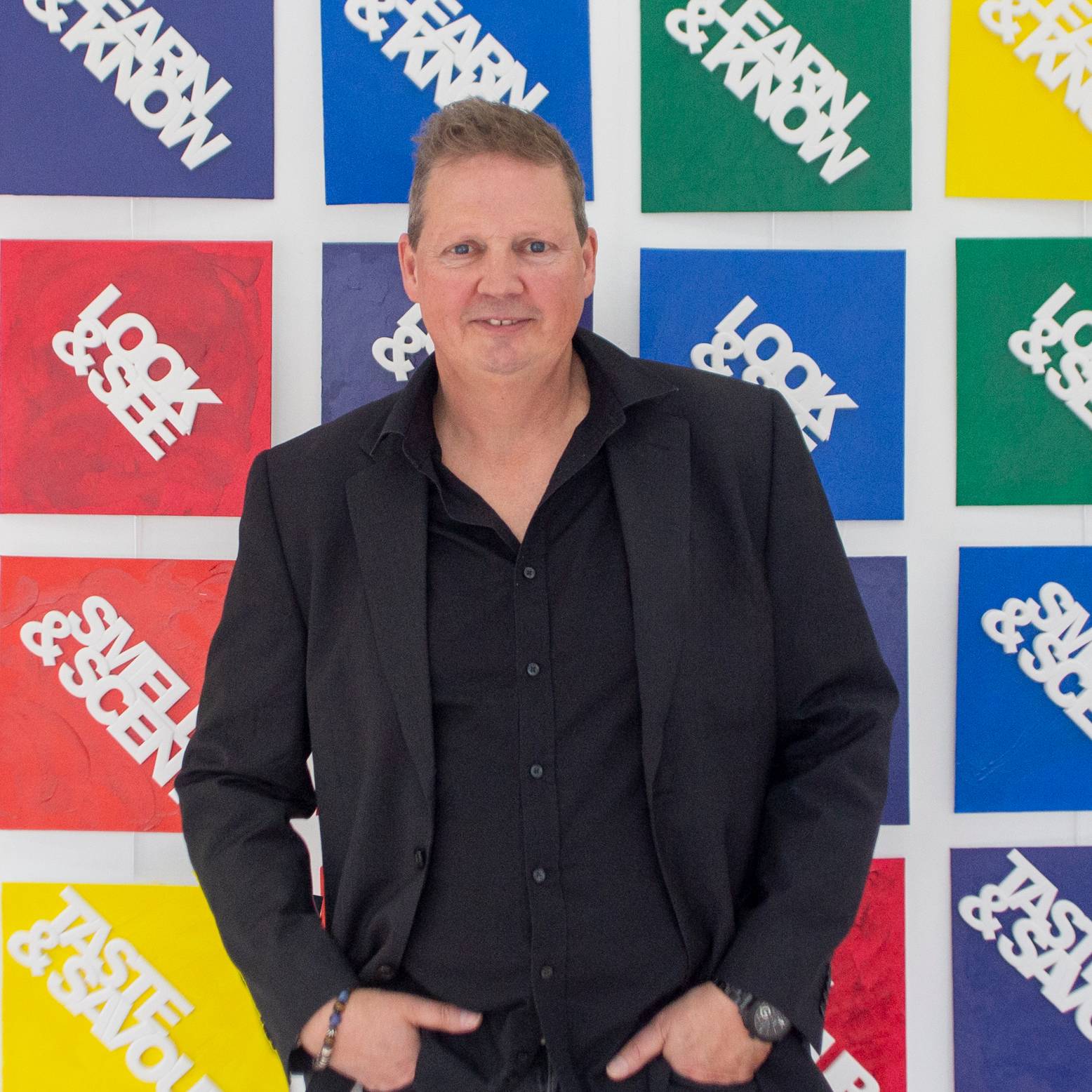 Profile picture of Steit standing in front of the Myths Original paintings