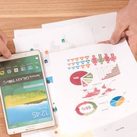 person holding white Samsung Galaxy Tab