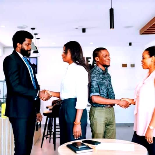 A group of people shaking hands in a room