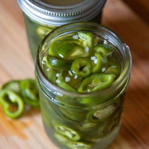 an open jar of pickled jalapenos 