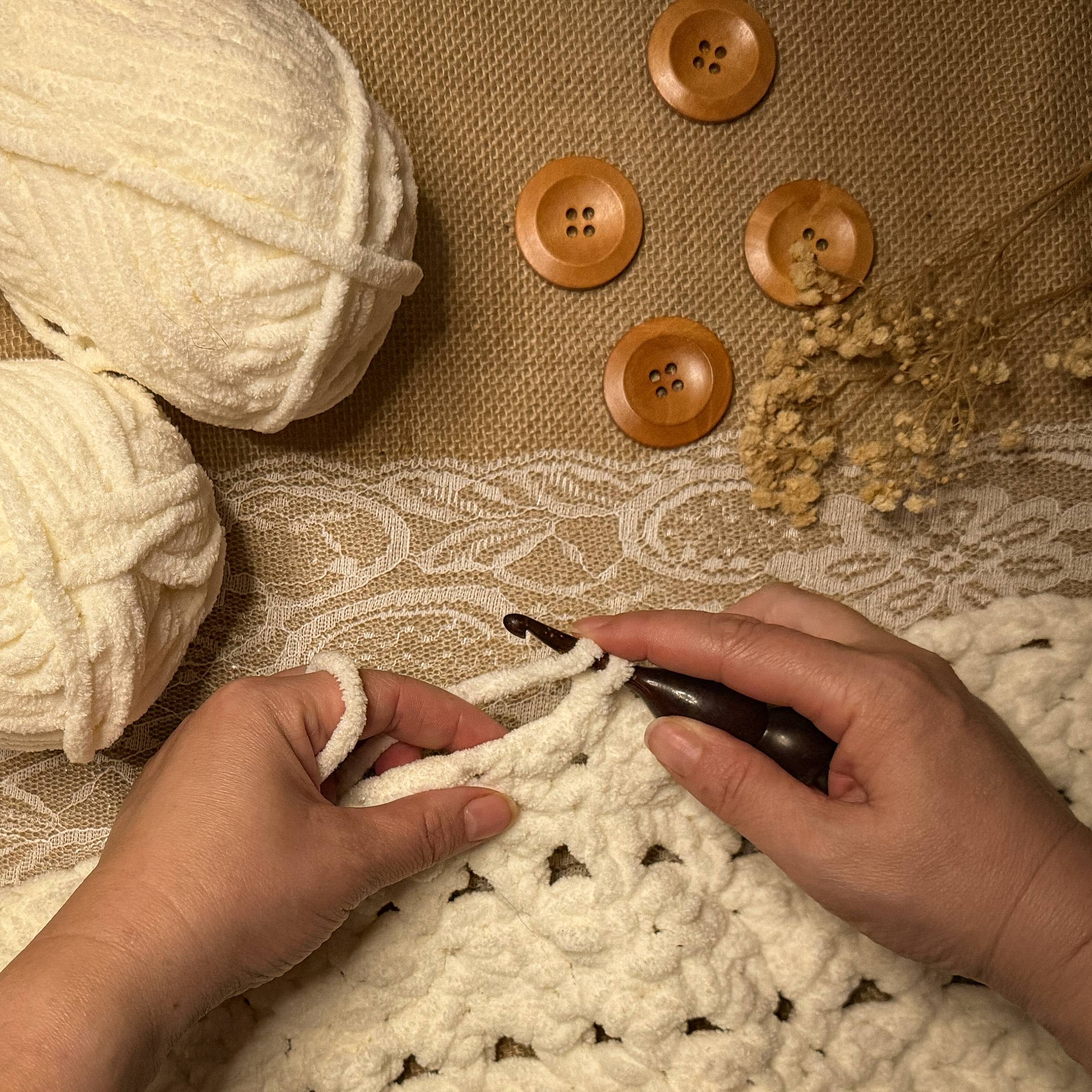 Crochet beginner holding yarn and hook while starting a stitch, demonstrating how to crochet for beginners step by step.