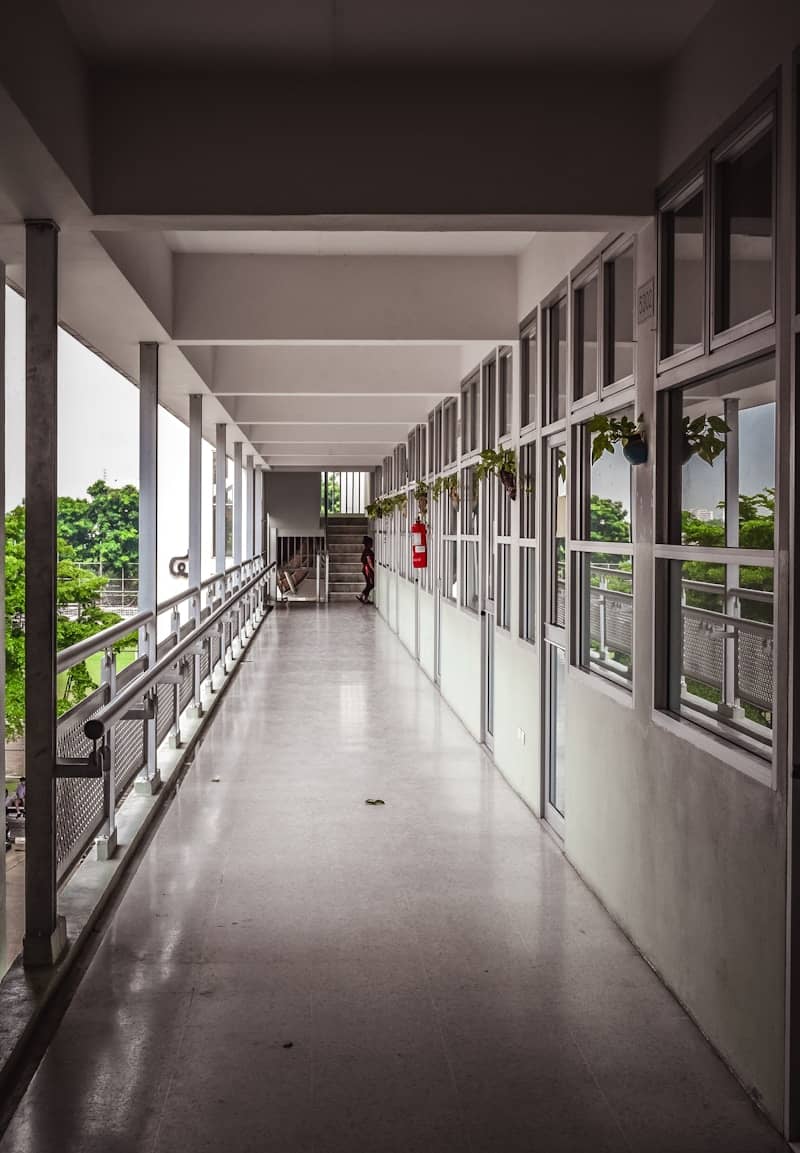 A long hallway with lots of windows and railings