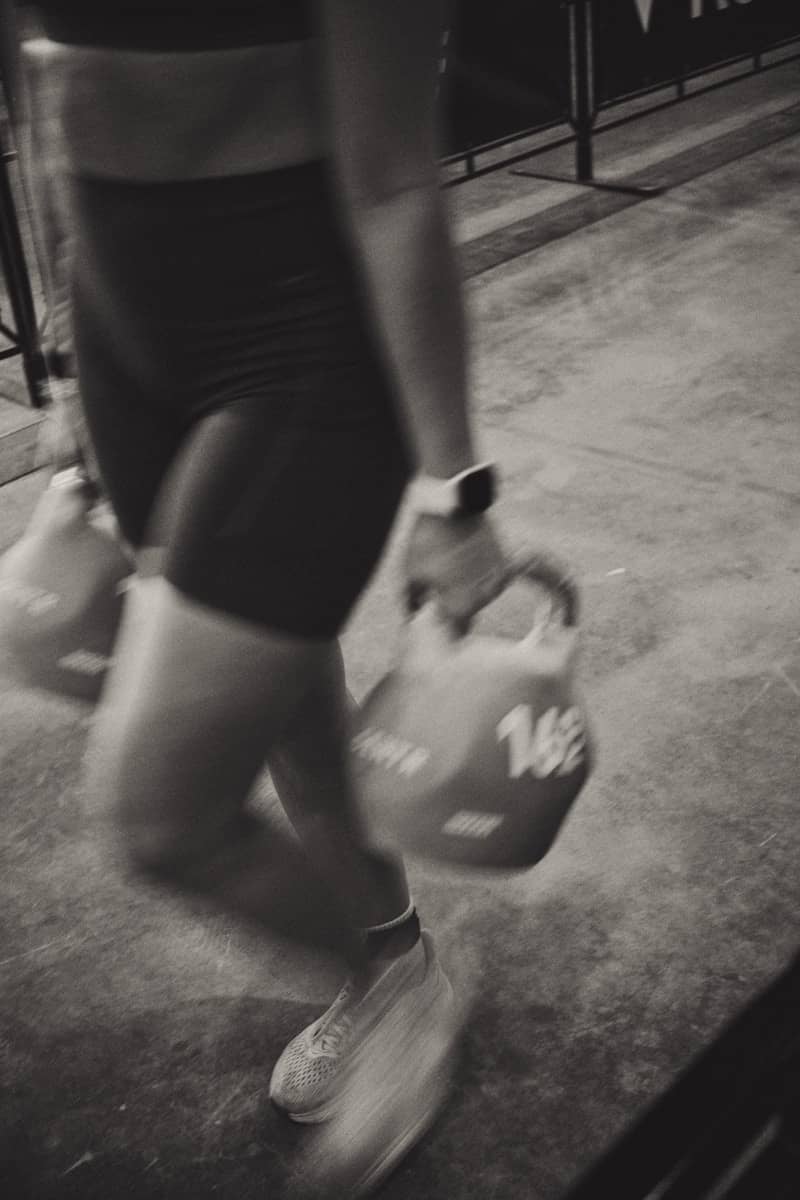 Person carrying kettlebells during workout