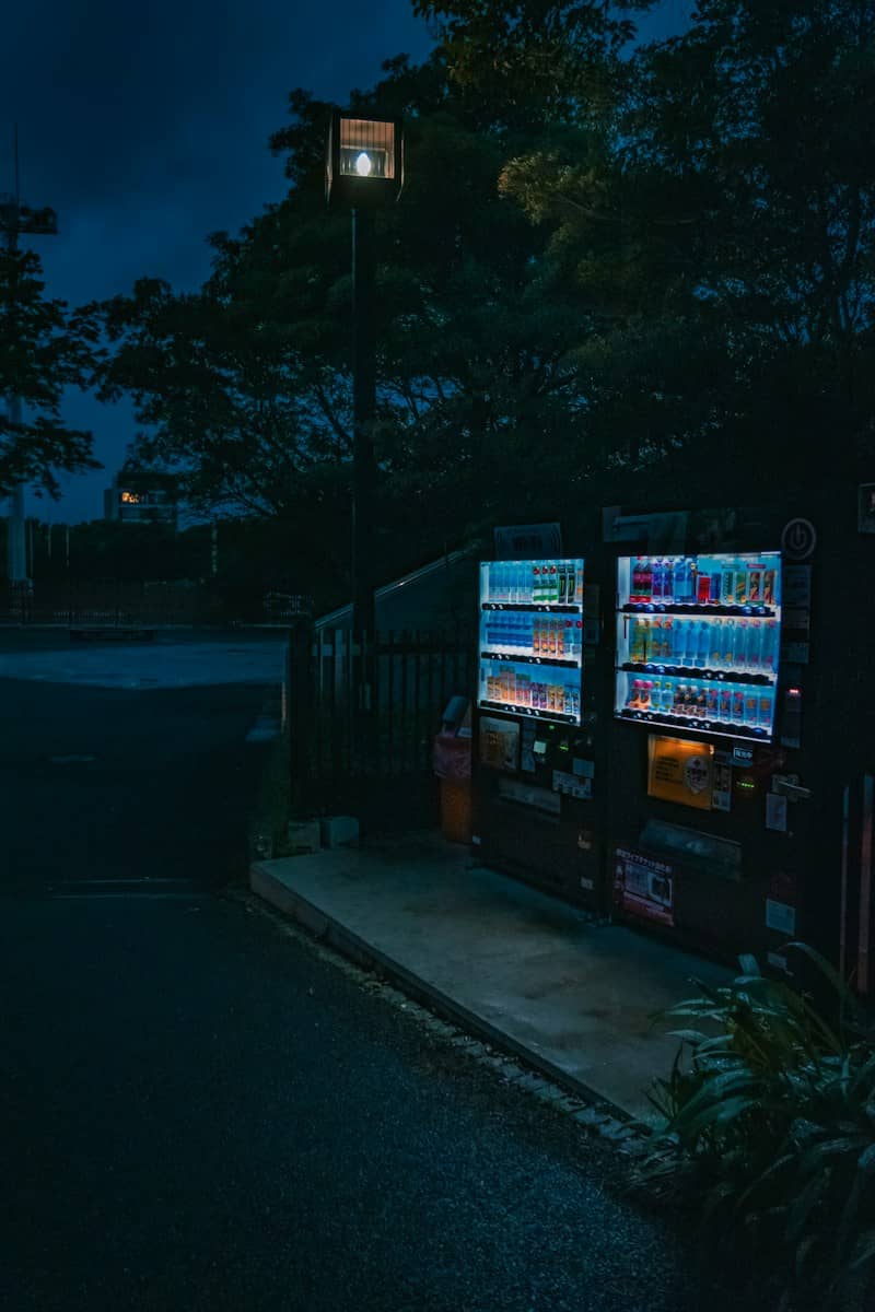 Nighttime scene with glowing vending machines.