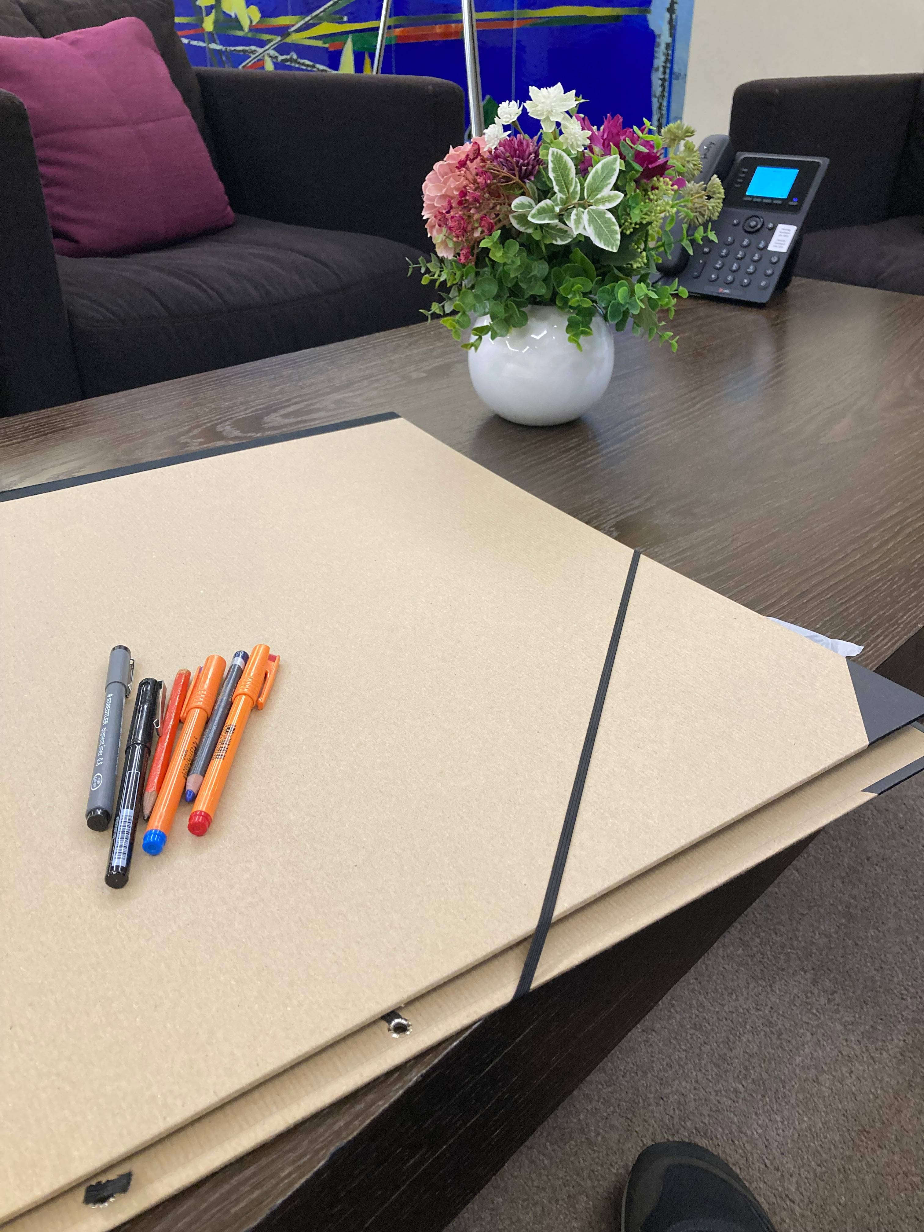 Pens on a portfolio, on a table. 