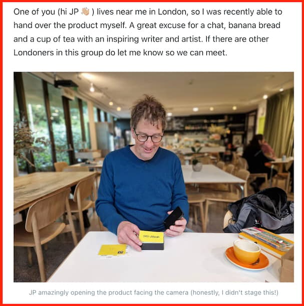 John-Paul Flintoff in a cafe, opening a packet of yellow cards