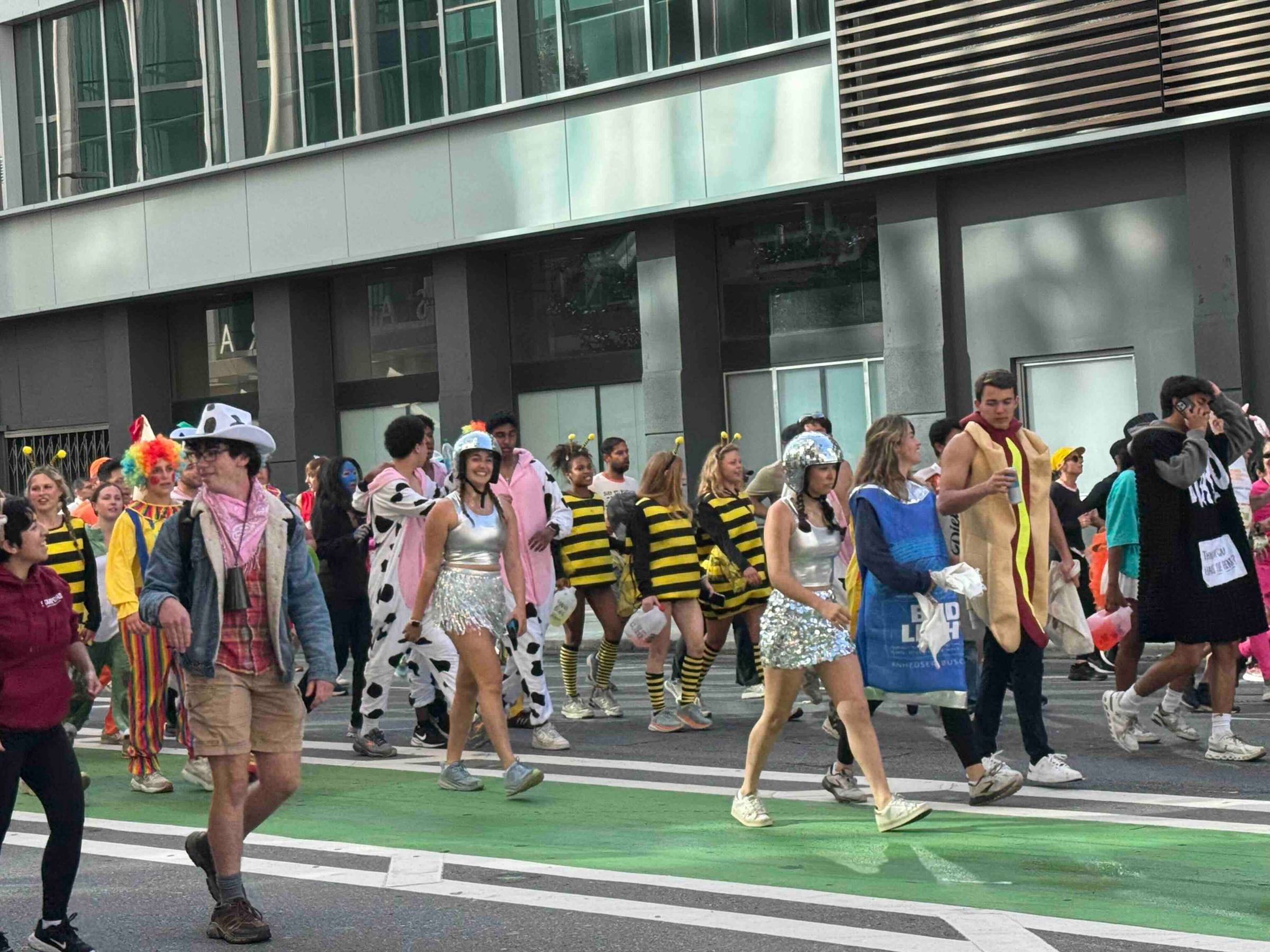 costumed crowd walking on street