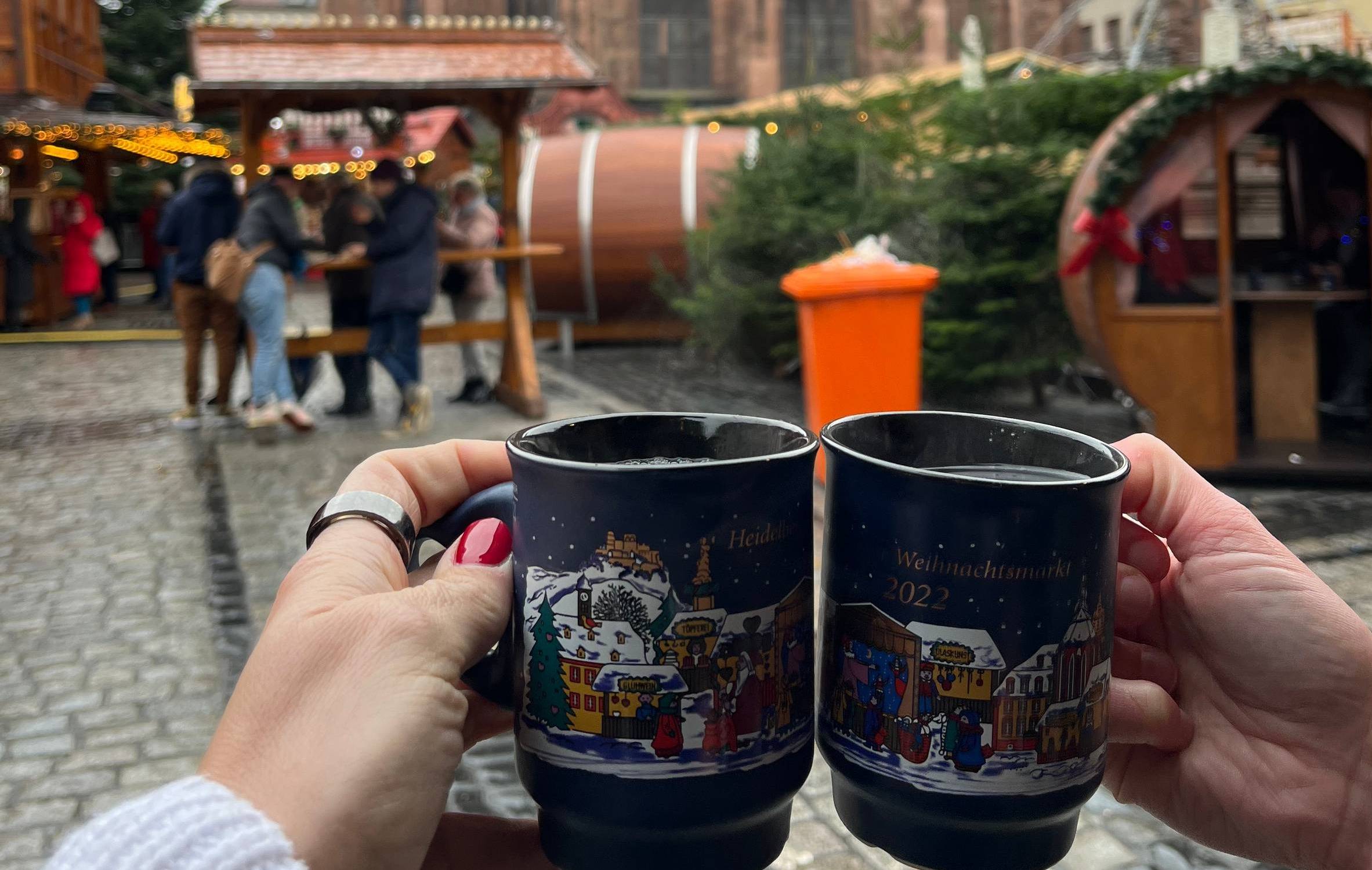 cheers of mugs at heidelberg christmas market