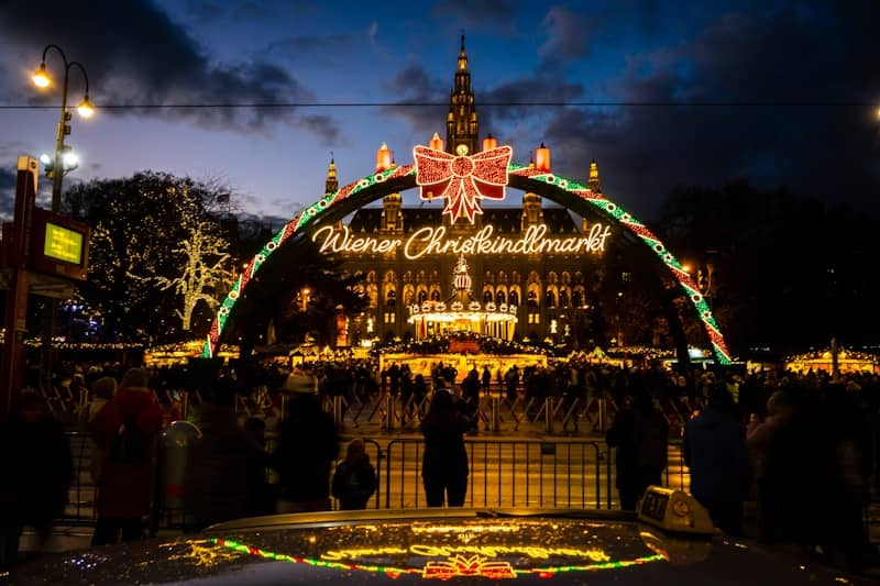 Christmas market archway with illuminated building at night