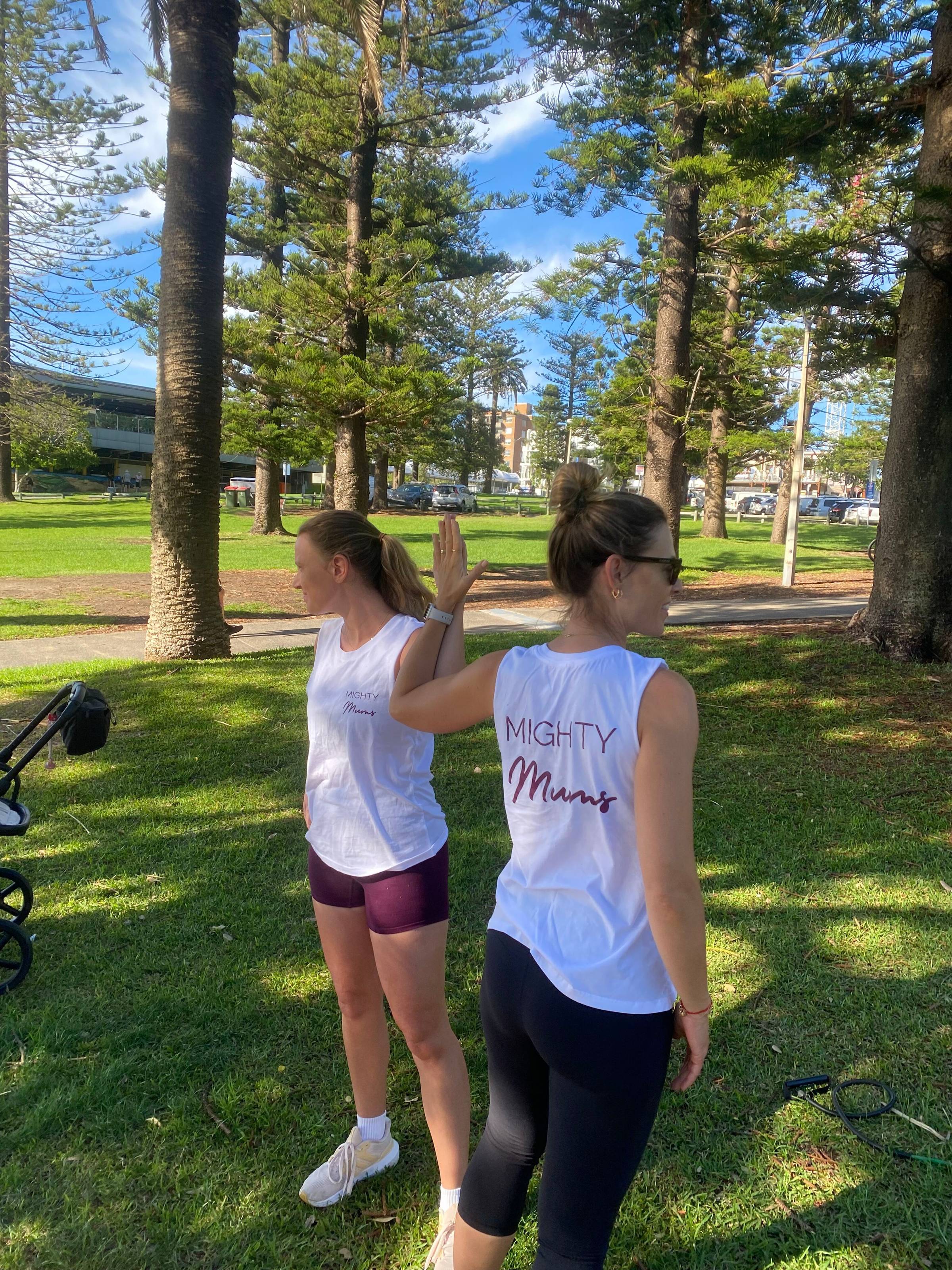 Two women holding a chest stretch