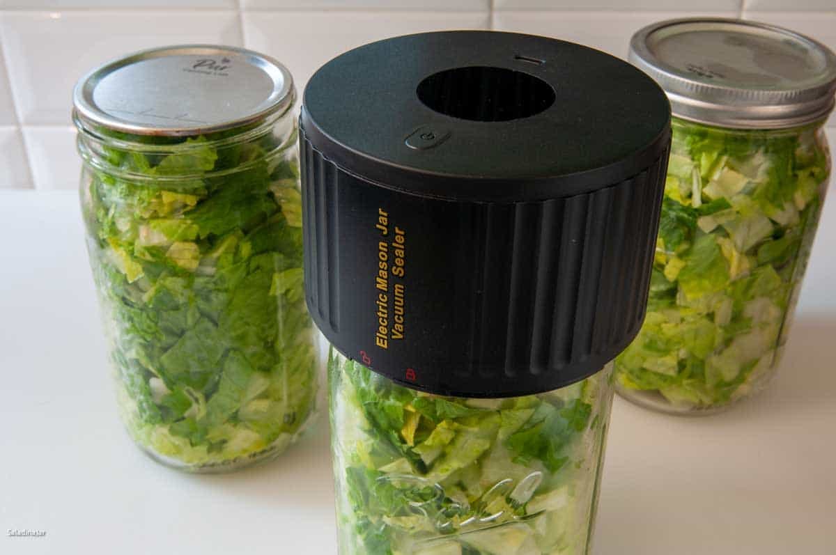 shows three jars of vacuum-sealed chopped lettuce using the electric Mason Jar Vacuum Sealer