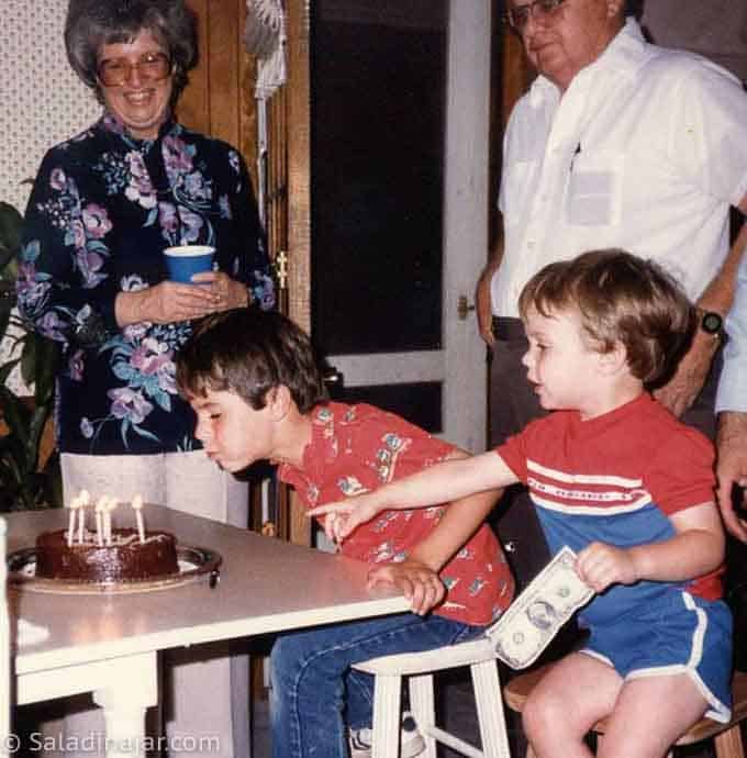 picture of boy blowing out candles on a birthday cakee