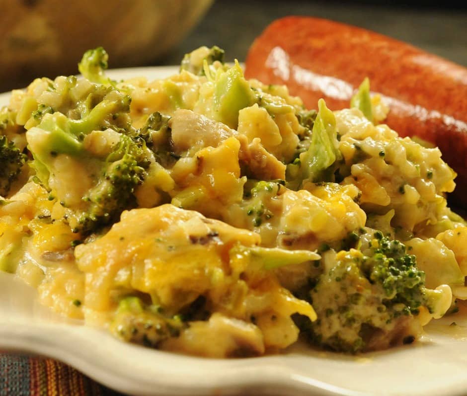 broccoli cheese and rice casserole on a plate with sausage