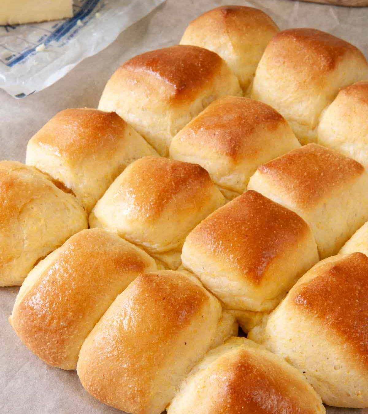 Yeasty cornbread dinner rolls with butter for brushing the tops.