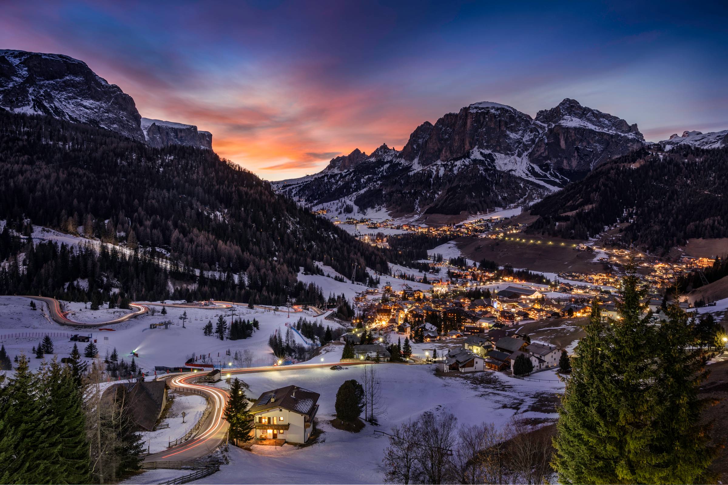 Evening lights glowing across the snowy mountain village of Les Arcs in the French Alps at dusk