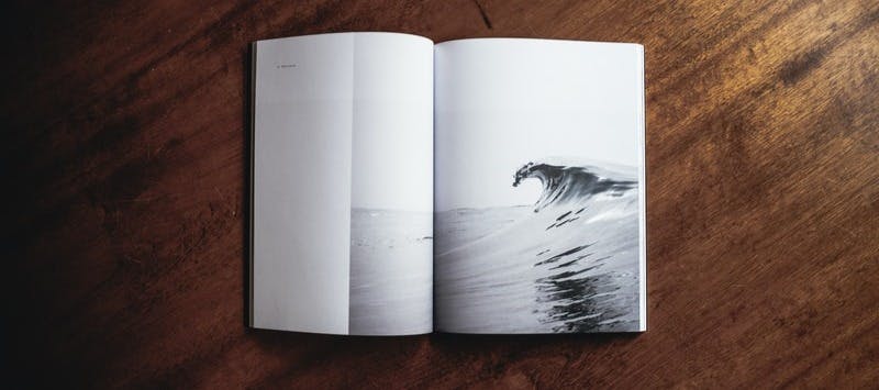 book opened on brown wooden table