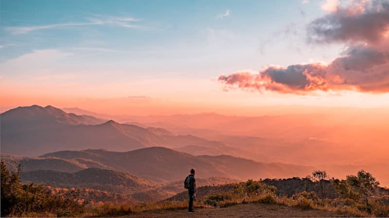 man standing on hill digital wallpaper