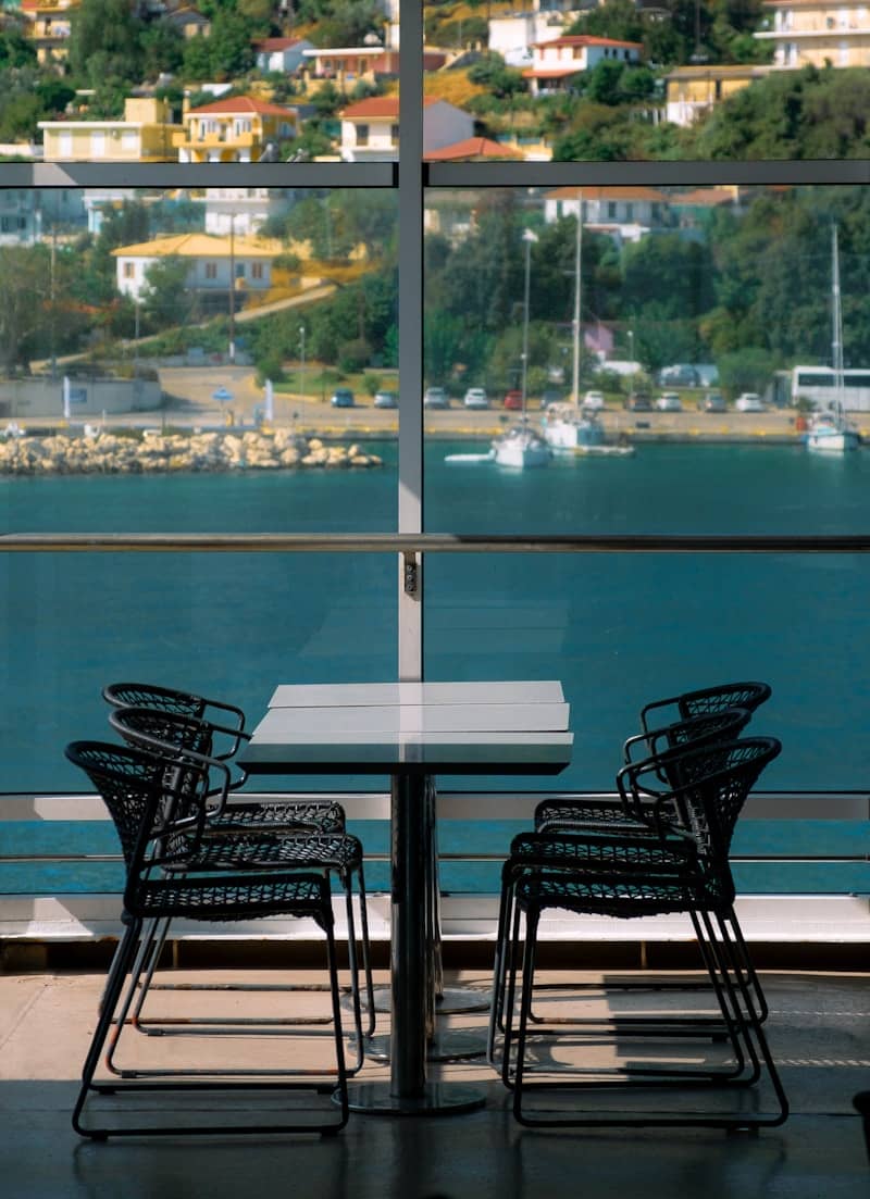 A table and chairs with a view of the water