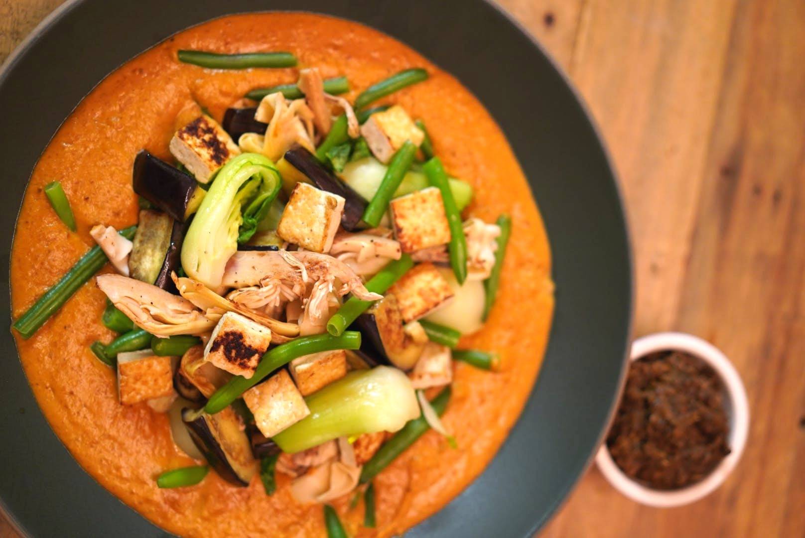 brown and green food in white ceramic bowl