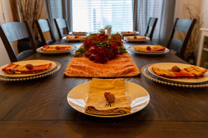 A dining room table with plates of food on it